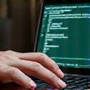 Person looking at a laptop screen with technical elements